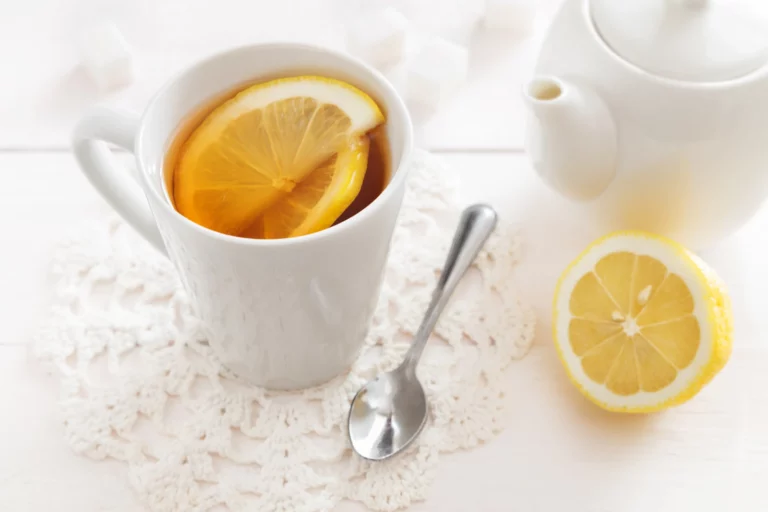 Tasse de boisson chaude avec des tranches de citron et une cuillère